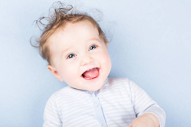 istock Beautiful laughing baby on a blue blanket 474465021