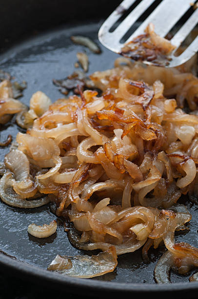 Caramelized Onion Caramelized onion in a frying pan. sauteed stock pictures, royalty-free photos & images