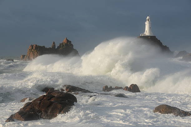 White lighthouse in stormy weather on the cliff, photomontage.