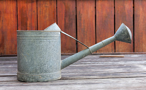 istock Metal watering pot side on wood floor 474469772