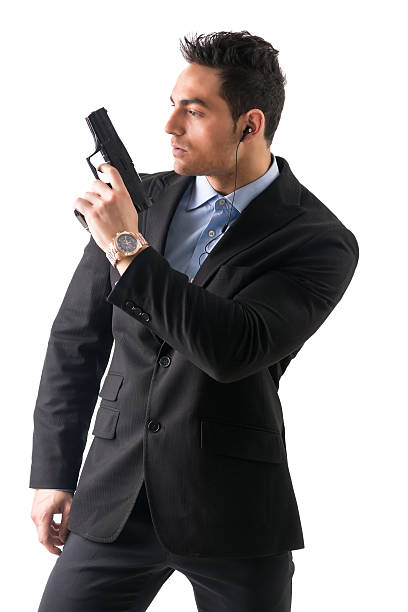 istock Elegant man with gun, dressed as a spy or secret 474470192