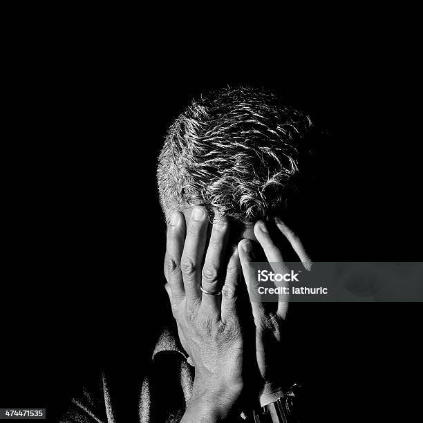 Man Frustrated And Ashamed With Hands On Face Stock Photo - Download Image Now - Anxiety, Black And White, Grief