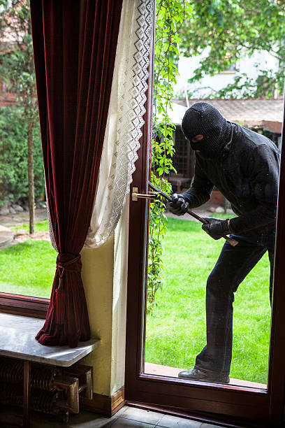 istock Burglar entering through the balcony window 474472442