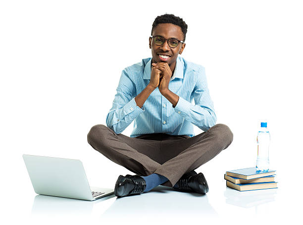 istock Happy african american college student sitting on white with laptop 474472900