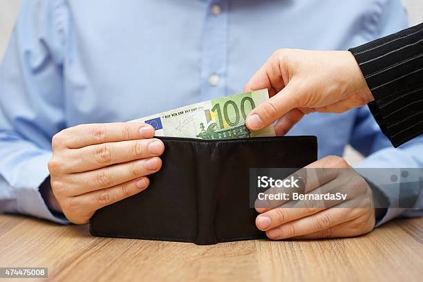 Woman Is Taking Money Out Of A Husbands Wallet Stock Photo - Download Image Now - Currency, Demanding, 2015