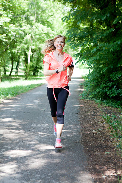 Beautifull middle age woman jogging in park