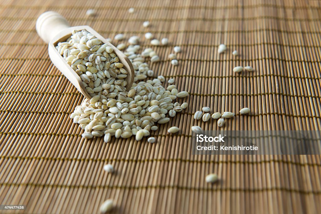 Barley Close up of barley in wooden scoop on bamboo mat 2015 Stock Photo