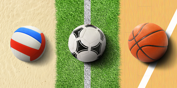 Sports balls, soccer ball on grass, basketball and volleyball