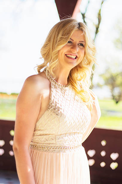 istock Blond woman in evening gown posing 474478174