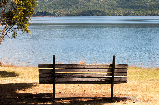 wooden bench next to Lake Tekapo in New Zealand