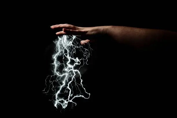 Witches hand casting a lightning spell.