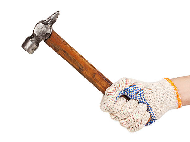 istock Working hand in glove holding a hammer 474480479