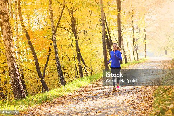 Active And Sporty Woman Runner In Autumn Nature Stock Photo - Download Image Now - Running, Autumn, Jogging