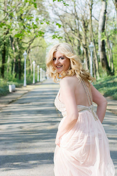 istock Blond woman in evening gown running 474483968