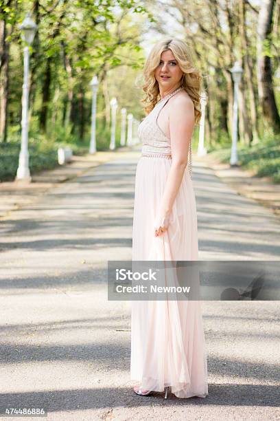 Blond Woman In Evening Gown Posing Stock Photo - Download Image Now - Blond Hair, Evening Gown, Silk