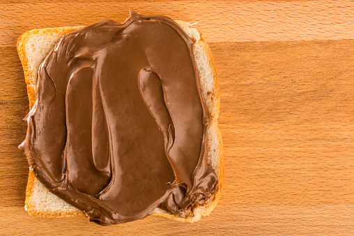 Chocolate cream toast over wood table. Dark chocolate cream sandwich