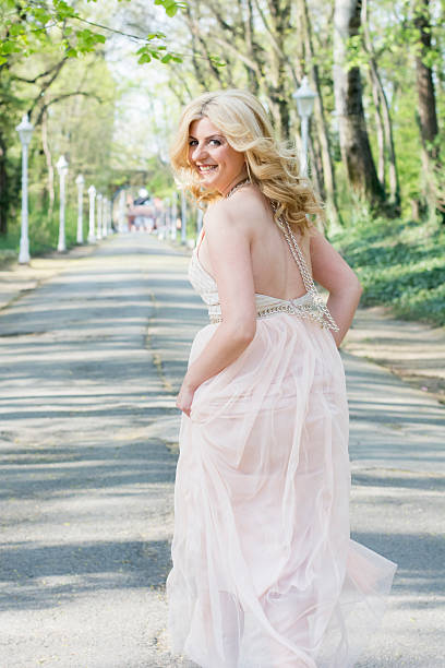 istock Blond woman in evening gown running 474487258