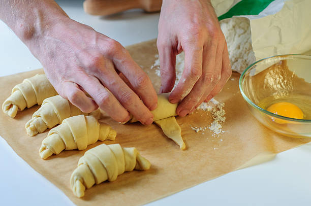 istock Croissants hands cooking on table with flour and baking paper 474487548