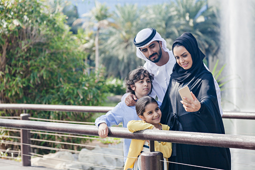 Middle Eastern Family Taking Selfie Outdoors Using Smart Phone