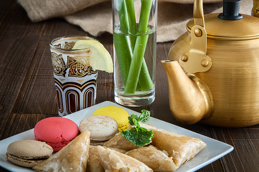 Arabian golden teapot on white wooden tableArabian golden teapot on white wooden table
