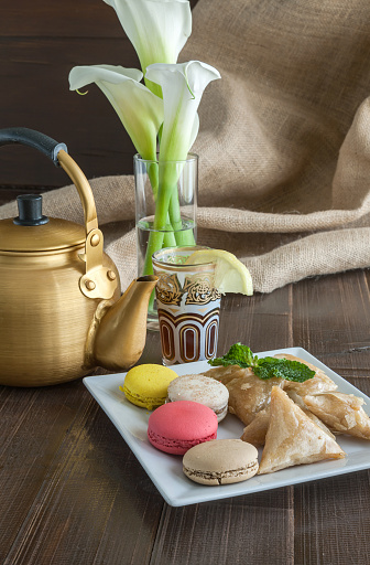 Arabian golden teapot on white wooden tableArabian golden teapot on white wooden table