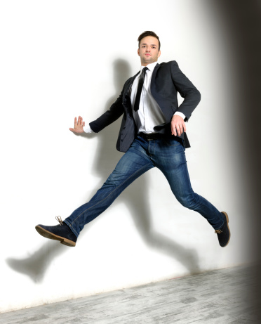 cool businessman jumping indoors.