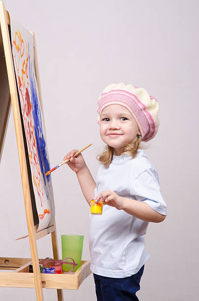 istock Girl artist paints on canvas 474493515