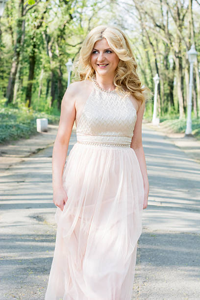 istock Blond woman in evening gown running 474495994