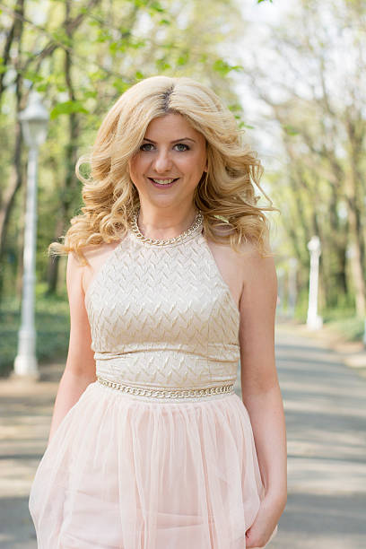Blond woman in evening gown running
