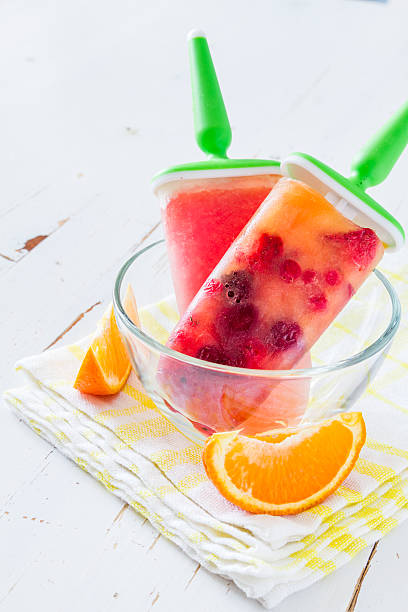 istock Fruit ice pops in glass bowl, orange slices 474496192
