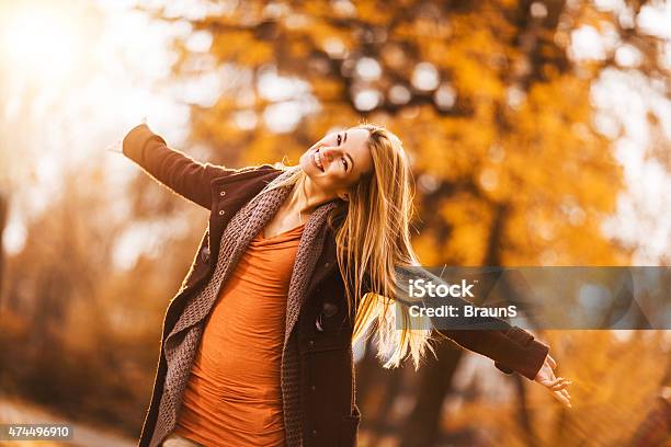 Carefree Woman Having Fun In Autumn Day Outdoors Stock Photo - Download Image Now - 2015, Adult, Adults Only