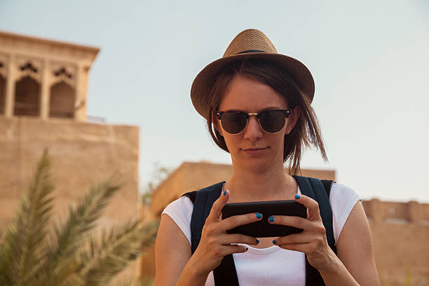 istock Young Tourist Woman Using Smart Phone 474497318