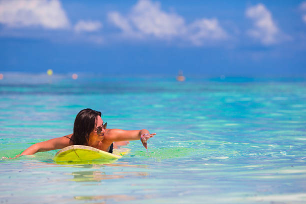 istock Young surfer woman surfing during beach vacation 474497686
