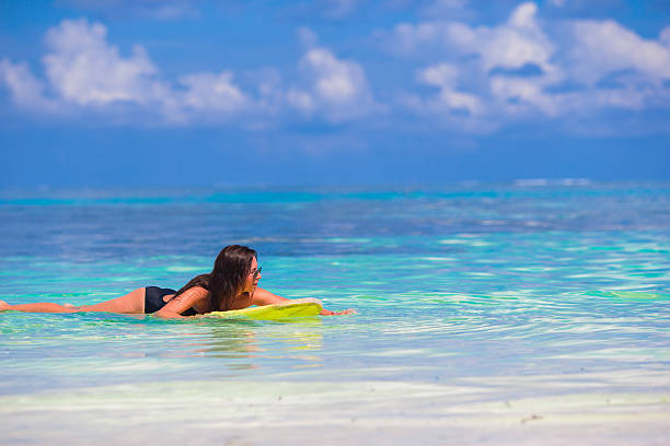 istock Beautiful surfer woman surfing during summer vacation 474497690