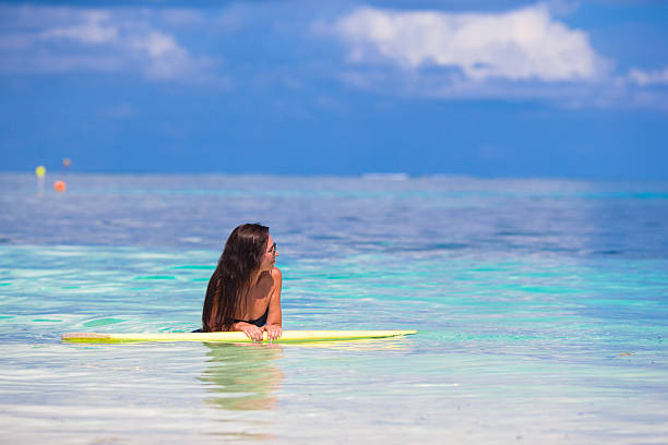istock Young surfer woman surfing during beach vacation 474497696
