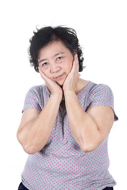 istock Asian senior female having a toothache holding his face 474498134