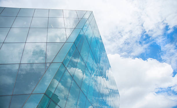 Modern Contemporary Glass Building Design Against A Blue Cloudscape