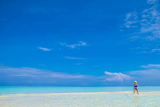 istock Young beautiful woman on beach during tropical vacation 474499540