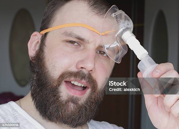 Bearded Man With An Asthma Inhaler To Breathe Health Stock Photo - Download Image Now