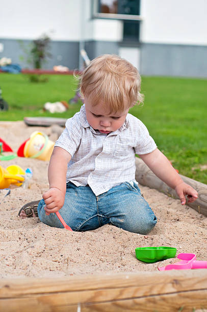 istock Child playing on playground in sandbox 474500922