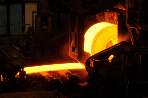 Hot orange steel rolling process in a steel manufacturing industry. Hot rolling is a metalworking process used mainly to produce sheet metal or simple cross sections, such as rail tracks. Other typical uses for hot rolled metal includes truck frames, automotive wheels, pipe and tubular, water heaters, agriculture equipment,  compressor shells, rail car components, wheel rims, metal buildings, railroad-hopper cars, doors, shelving, discs, guard rails, automotive clutch plates.