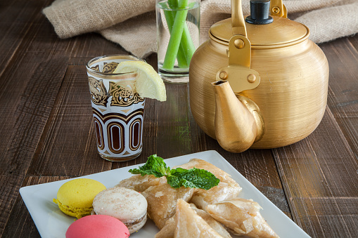 Arabian golden teapot on white wooden tableArabian golden teapot on white wooden table