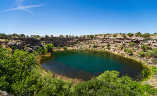 Montezuma Well is part of Montezuma Castle National Monument in Arizona, USA. Ancient cliff dwelling is visible on the left side of the photograph.