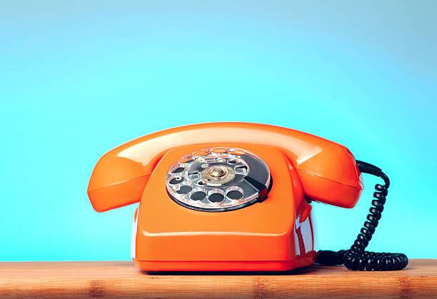 istock Vintage orange phone on the table 474502132