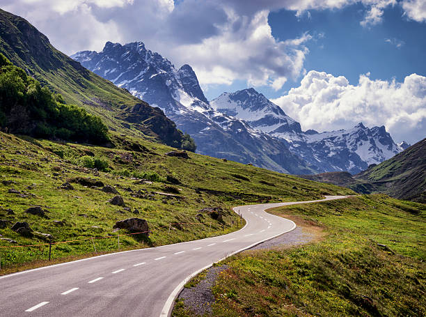 country road country road at the european alps winding road mountain stock pictures, royalty-free photos & images