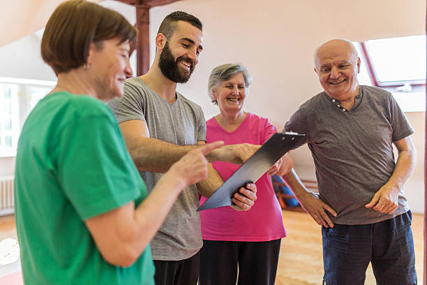 istock Young coach making an exercise plan for group of seniors. 474504462
