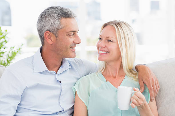 istock Woman holding coffee cup while looking at man 474504698