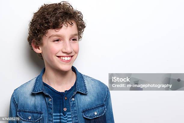 Cute Little Boy With Curly Hair Smiling Stock Photo - Download Image Now - 12-13 Years, Boys, Child