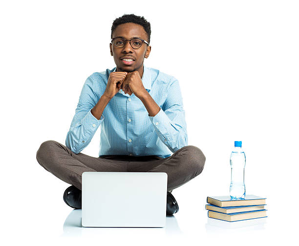 istock Happy african american college student sitting with laptop on white 474505280