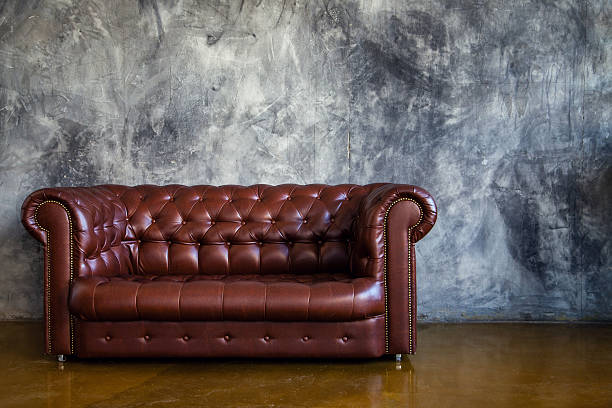 istock Leather brown sofa in urban loft interior 474505540
